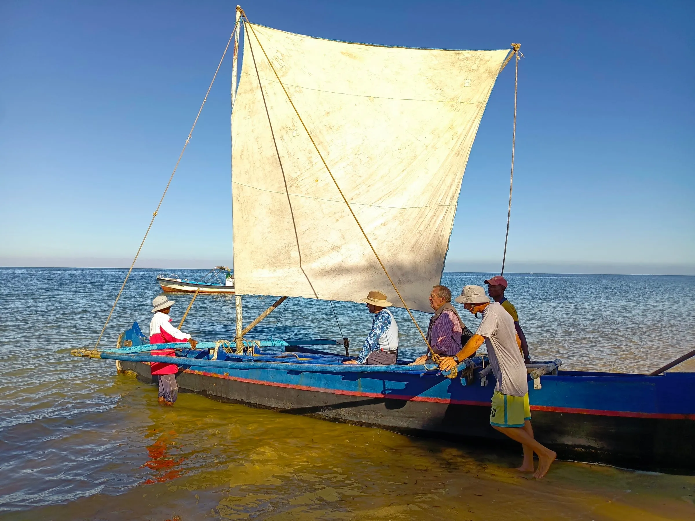 Setting off from the beach in a sailing pirogue