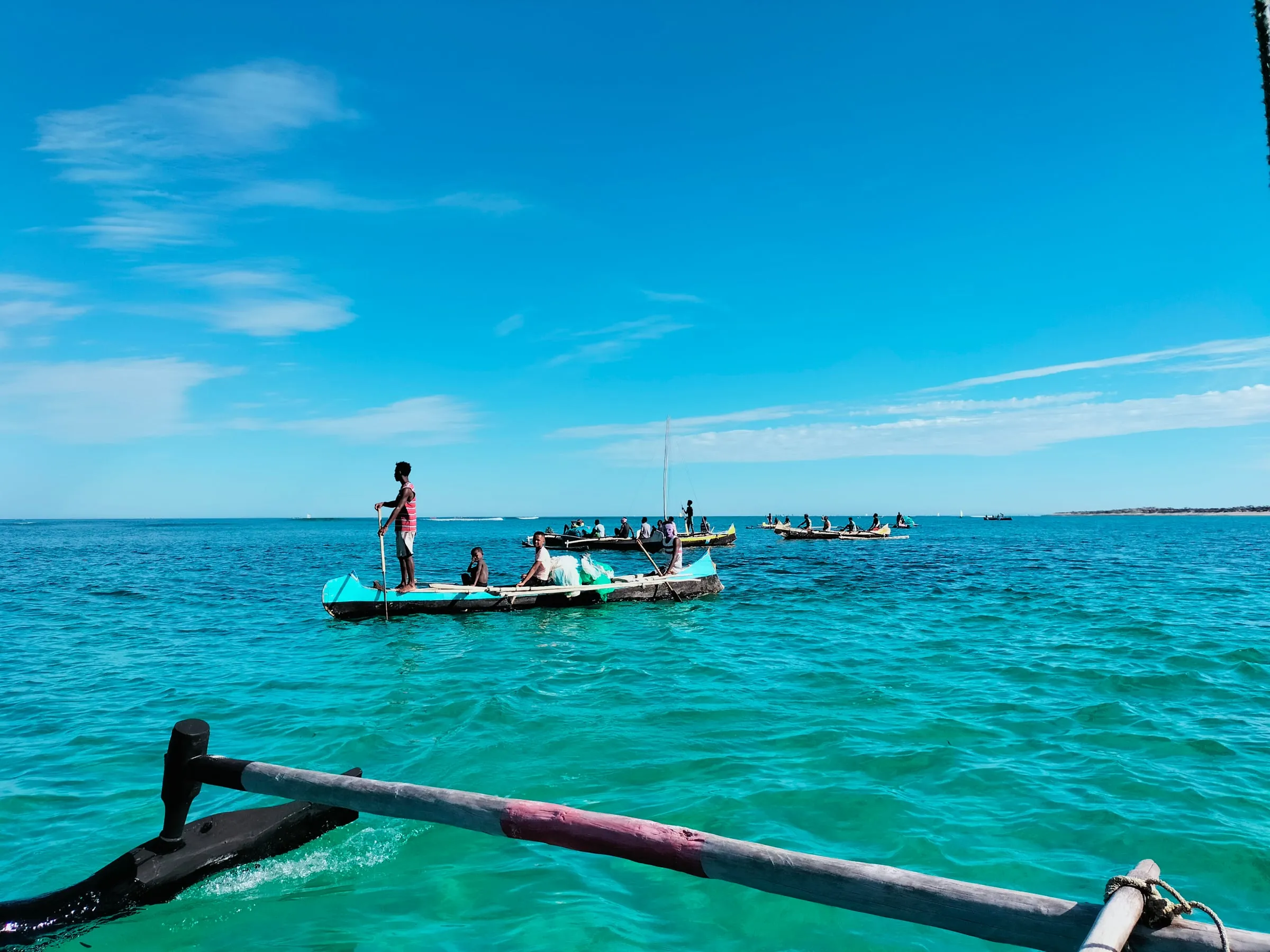 Fishermen in a pirogue on the turquoise lagoon of the southwest coast